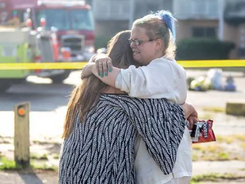 Hotel residents Cassundra Clements, left, and Sarah Sanders comfort one another after a fire at the Cosmo Extended Stay Motel in Sodus Township, Mich. (AP)