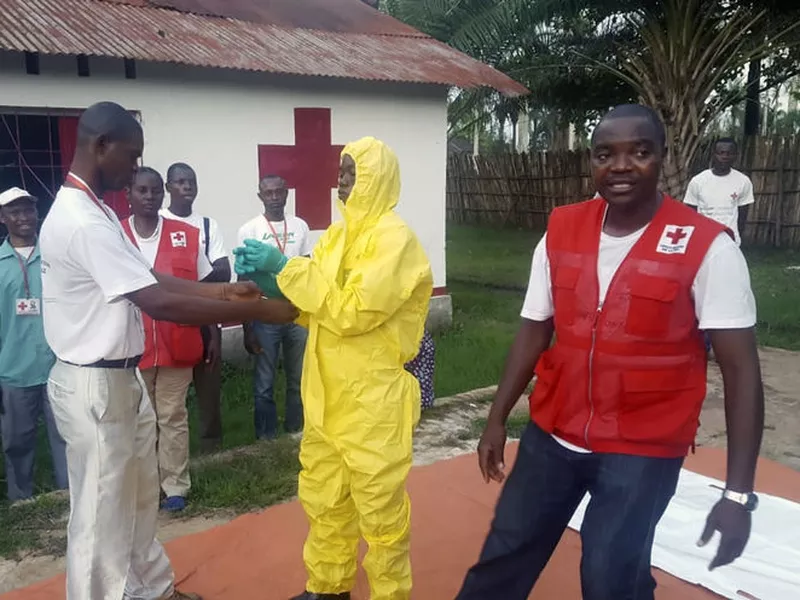 Members of a Red Cross team don protective clothing before heading out to
look for suspected victims of Ebola.