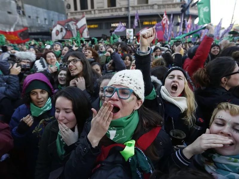 Women celebrate the approval of a bill legalizing abortion by the lower house of congress, in Buenos Aires.