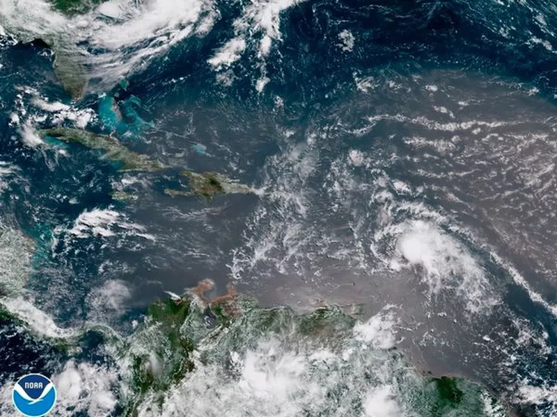 In this geocolor image GOES-16 satellite image taken Sunday, July 8, 2018, at 15:00 UTC, shows Tropical Storm Beryl, center right, moving across the Lesser Antilles in the eastern Caribbean.
