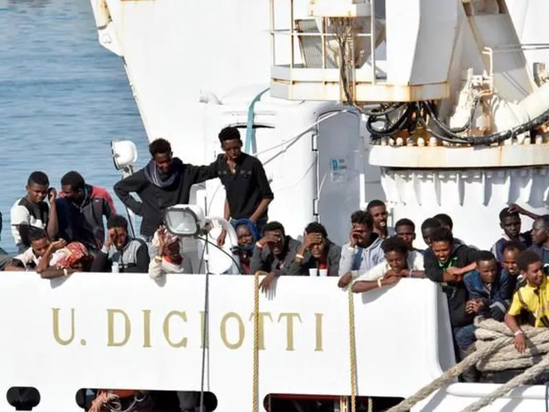 Migrants wait to disembark from an Italian Coast Guard vessell “Diciotti” as
it docks at the Sicilian port of Catania, southern Italy.
