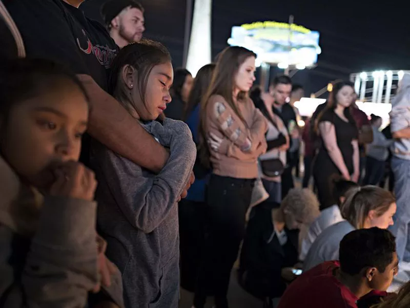 Attendees of a vigil for the victims of the latest school shooting in Texas, listen to speakers at the Arizona Capitol, in Phoenix.
