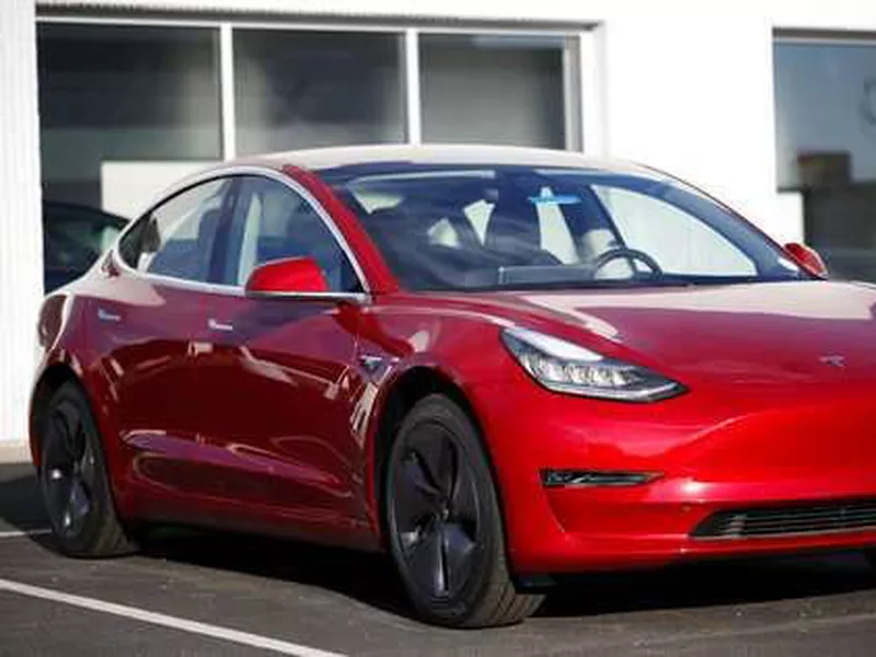 A 2018 Model 3 sedan sits at a Tesla dealership in Littleton, Colo.