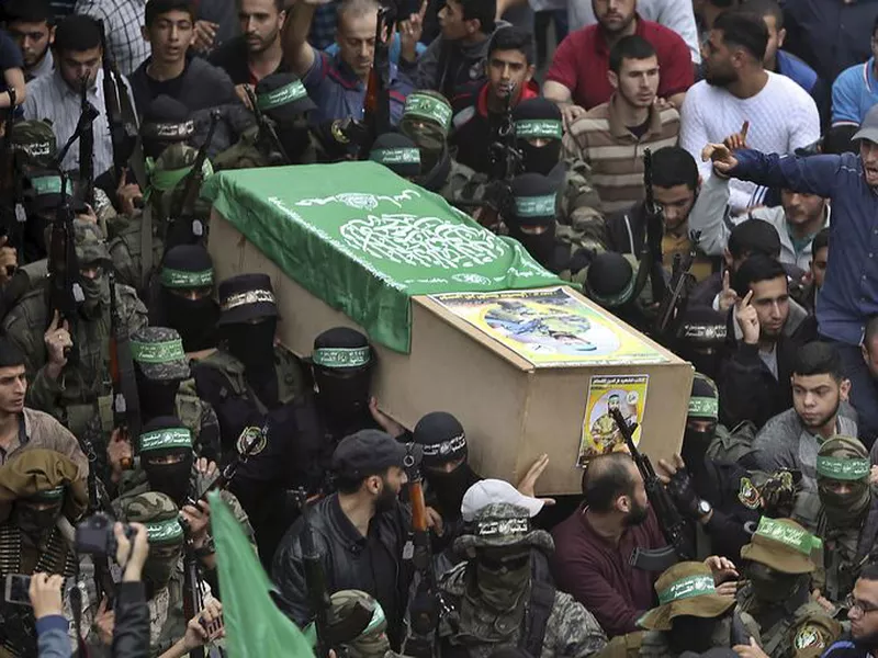 Masked Hamas gunmen carry the coffin of one of six of their fighters.