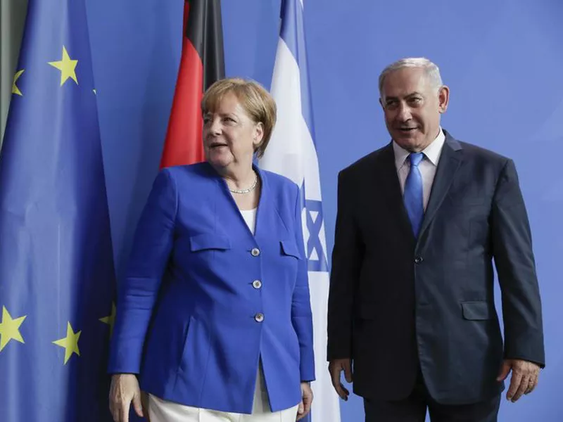 German Chancellor Angela Merkel, left, and Israel’s Prime Minister Benjamin Netanyahu, right, shake hands after a joint press conference in Berlin, Germany.