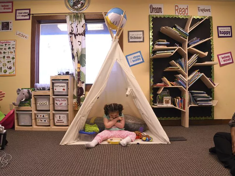 Addelyn Patrick, 5, sits inside a teepee in the playroom at Realm of Caring in Colorado Springs, Colo.
