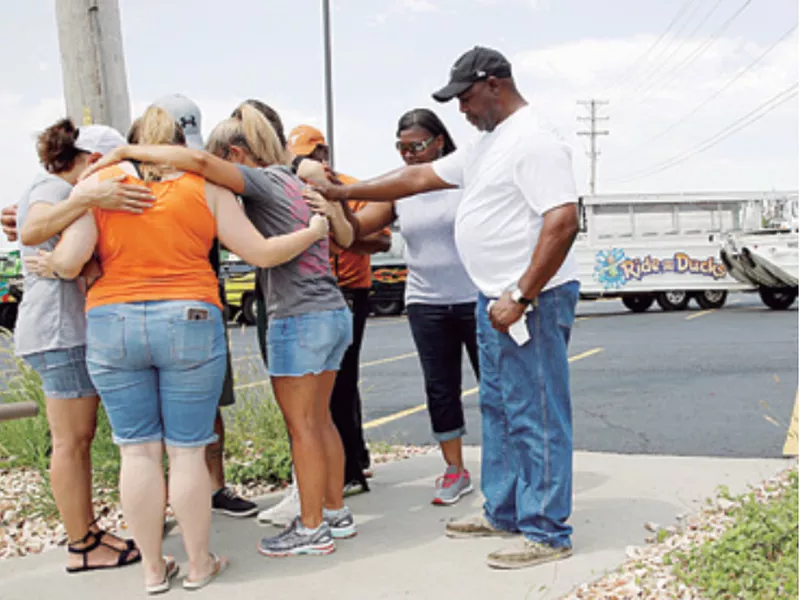 People pray outside Ride the Ducks, an amphibious tour operator involved in a boating accident on Table Rock Lake, in Branson, Mo. (AP)