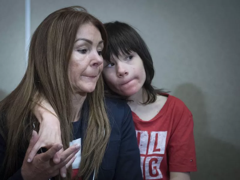 Billy Caldwell sits with his mother Charlotte. (AP)