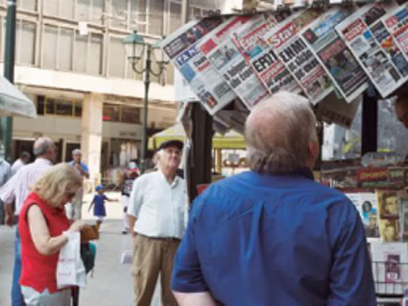 People read newspaper front pages a day after a Greek- Macedonian agreement, at a kiosk in Athens. (Ap)