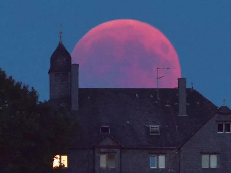 The moon turns red during a total lunar eclipse in Bernkastel-Kues, Germany. (AP)