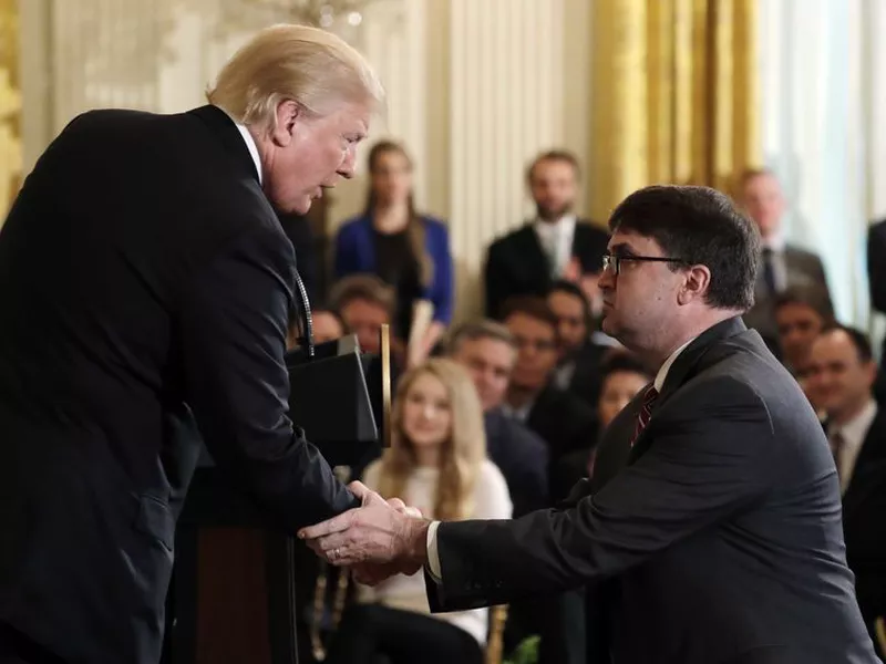 President Donald Trump shakes hands with Acting Veterans Affairs Secretary Robert Wilkie, during an event on prison reform in the East Room of the White House, in Washington. (AP)