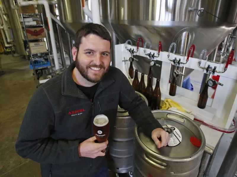 Pulitzer Prize winning photojournalist, Ryan Kelly, poses in the brewery at his new job at Ardent Craft Ales in Richmond, Va.