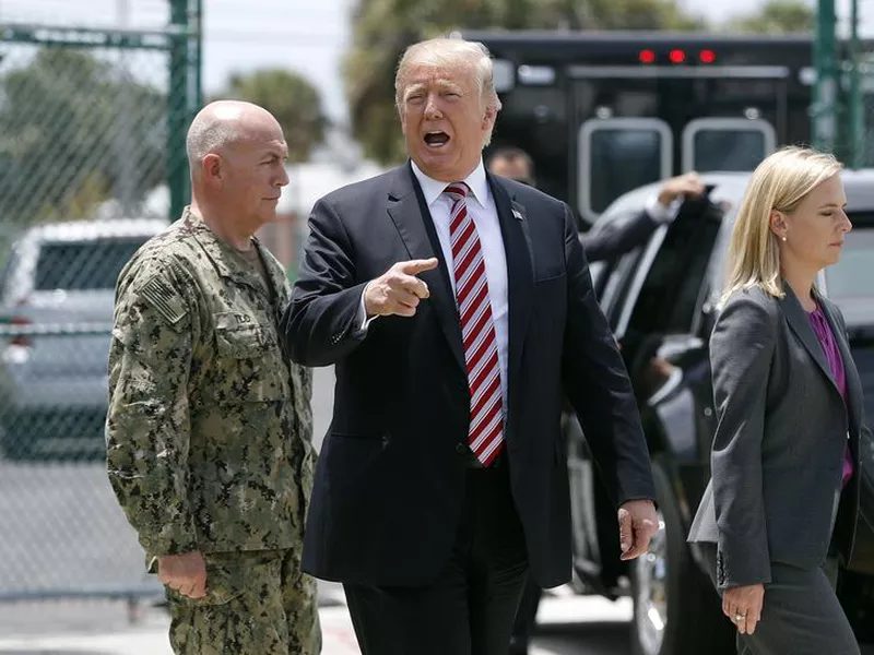 Donald Trump, center, speaks to members of the media during his visit to Joint Interagency Task Force South anti-smuggling center in Key West, Fla. (AP).