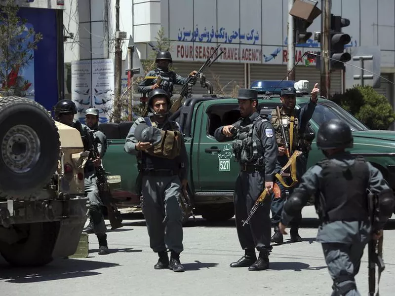 Afghan security personnel inspect the area of a suicide attack in the center of Kabul, Afghanistan. Three suicide bombers struck two police stations in
Afghanistan’s capital on Wednesday, wounding at least six people, officials said.