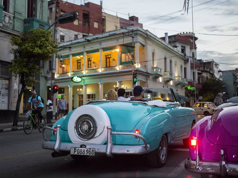 Tourists ride classic American convertibles in Havana, Cuba.