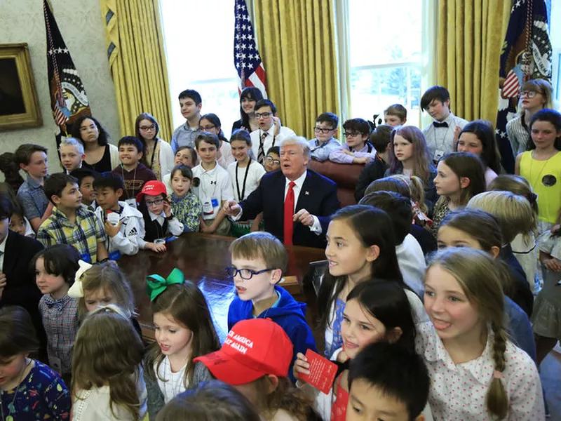 President Donald Trump is surrounded by children kids in the Oval Office in celebration of “Bring Our Daughters and Sons to Work Day” at the White House in Washington.