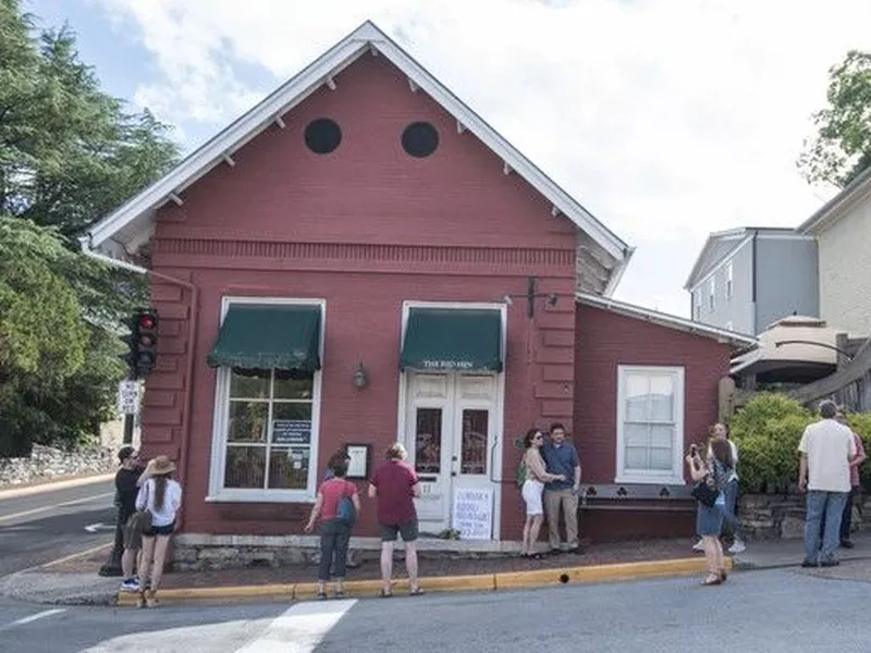 Passersby gather to take photos in front of the Red Hen Restaurant, Saturday, June 23, 2018, in Lexington, Va.