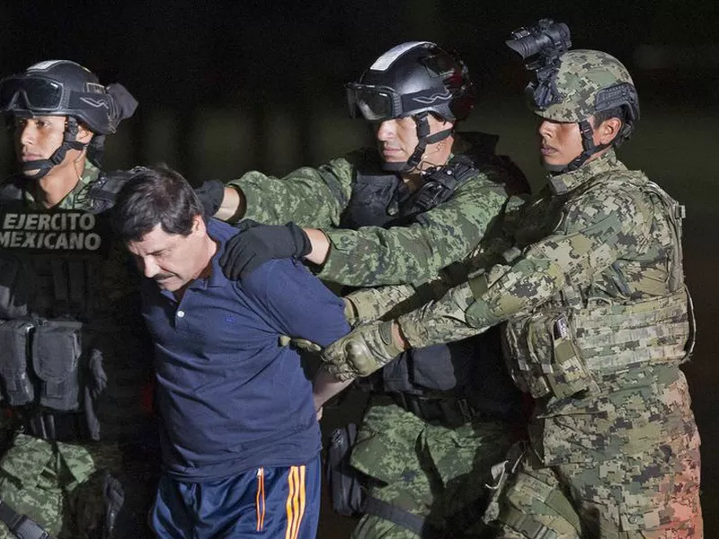 Joaquin “El Chapo” Guzman, the head of Mexico’s Sinaloa Cartel, being escorted to a helicopter in Mexico City following his capture overnight in the beach resort town of Mazatlan. The lawyer for Guzman says his client’s mental health is deteriorating.