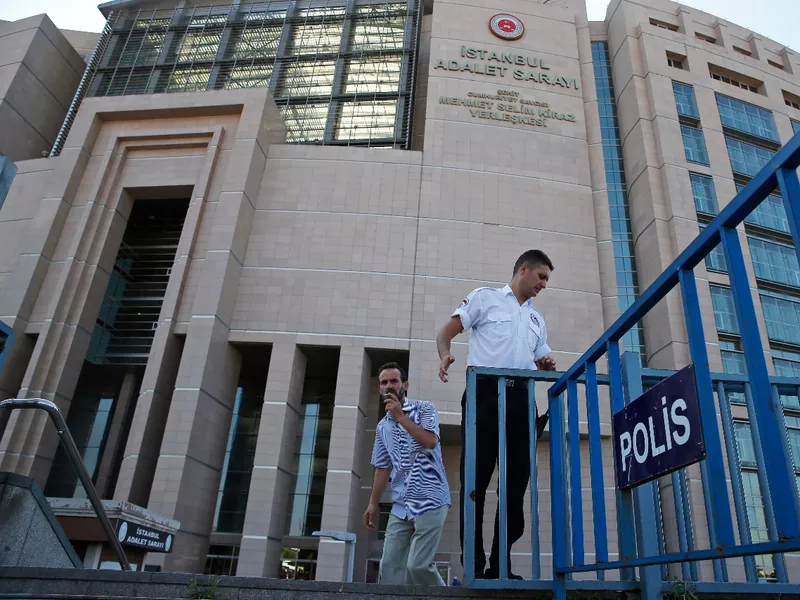 A security guard adjusts barriers outside a court where the trial of journalists
of the now-defunct Zaman newspaper on charges of aiding terror groups
was held, in Istanbul.