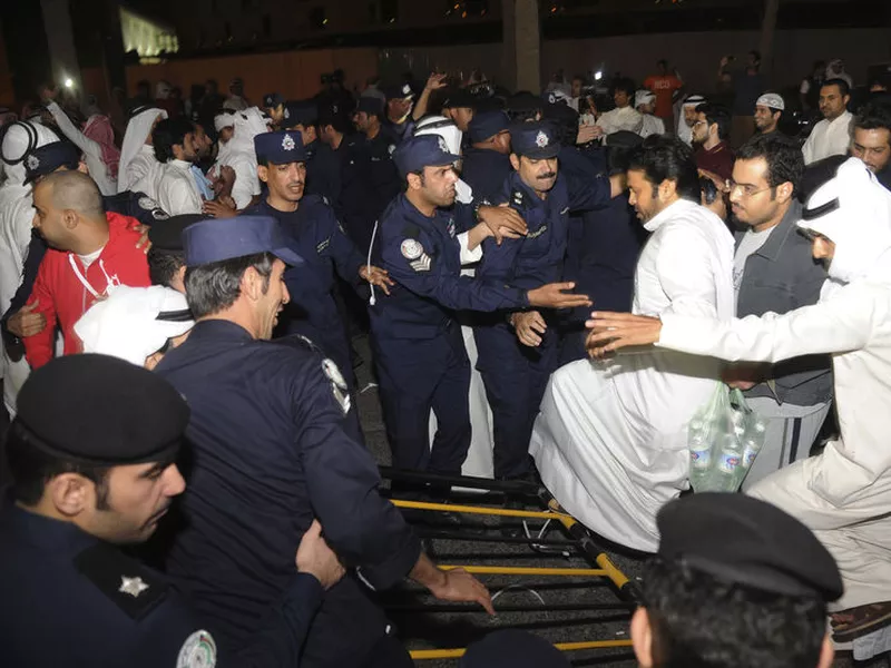 Dozens of Kuwaitis briefly storm Kuwait’s parliament building as hundreds of others protested outside in Kuwait City, Kuwait.