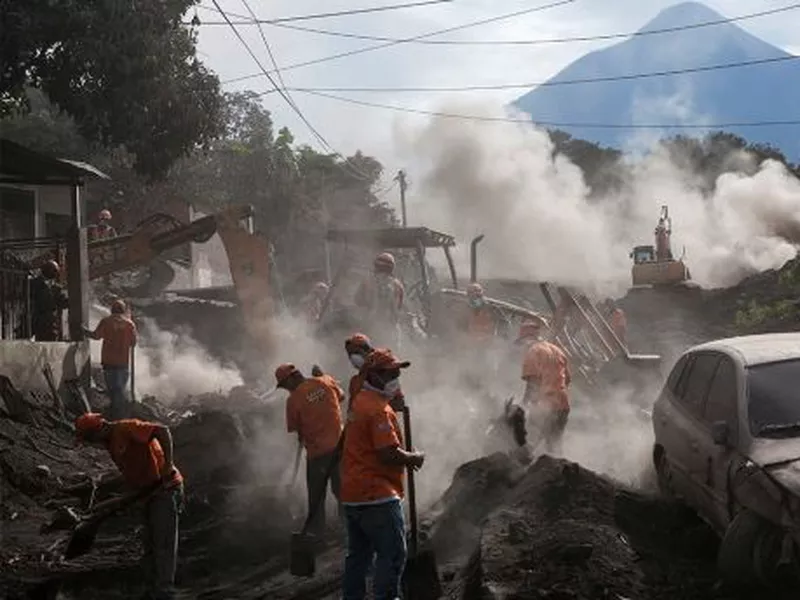 Rescue workers remove piles of ash spewed by the Volcan de
Fuego, or “Volcano of Fire,” eruption, in El Rodeo, Guatemala.