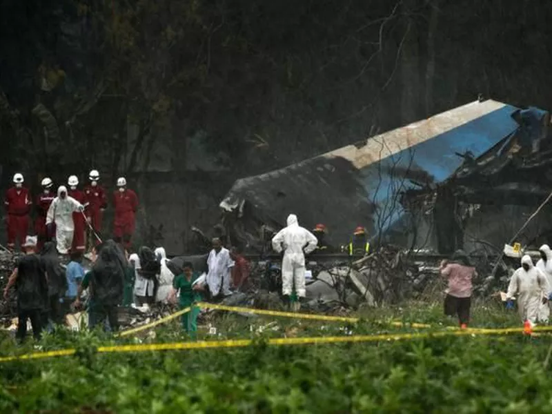 Rains begins to fall as rescue teams search through the wreckage site of Boeing 737 that plummeted into a yuca field with more than 100 passengers on board, in Havana, Cuba. (AP)