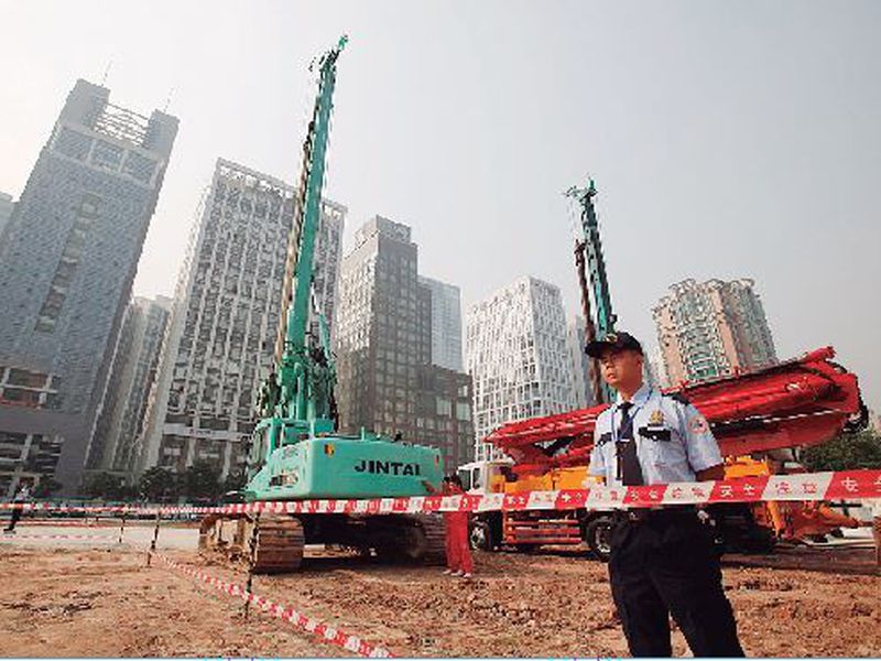Security workers guard at construction site of the U.S. Consulate compound in Guangzhou in southern China’s Guangdong province.
