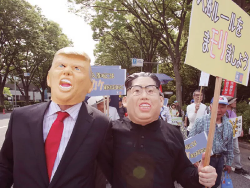 Protesters wearing masks of U.S. President Donald Trump, left, and North Korean leader Kim Jong Un, march in Tokyo. (AP)