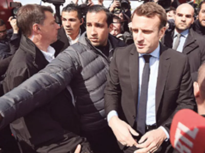 In this file photo French centrist presidential election candidate Emmanuel
Macron, flanked by his bodyguard, Alexandre Benalla, left, in Amiens, northern France.
