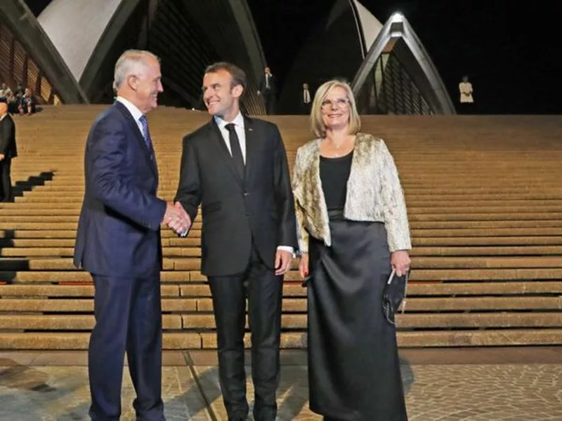 President Emmanuel Macron, center, poses with Australia’s Prime Minister Malcolm Turnbull, left, and his wife, Lucy, at the Sydney Opera House in Sydney, Australia.