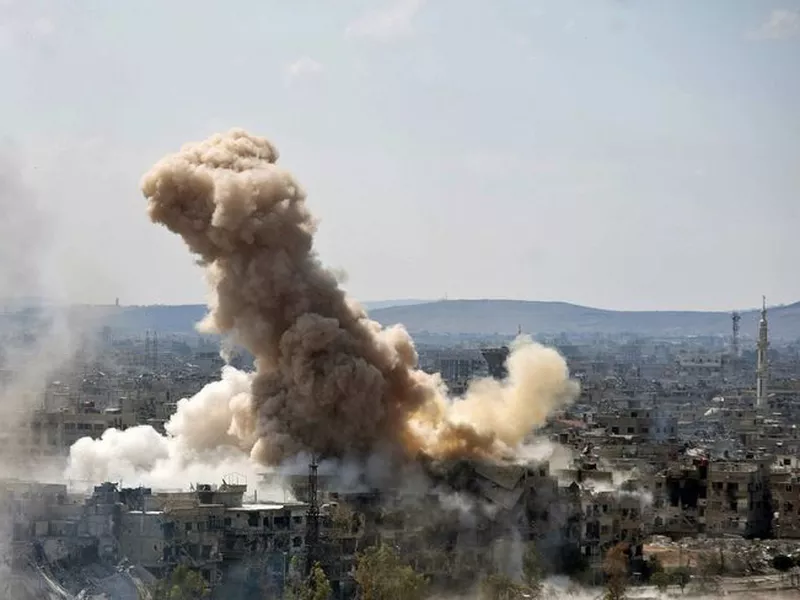 Smoke rises after Syrian government airstrikes southern Damascus, Syria.
