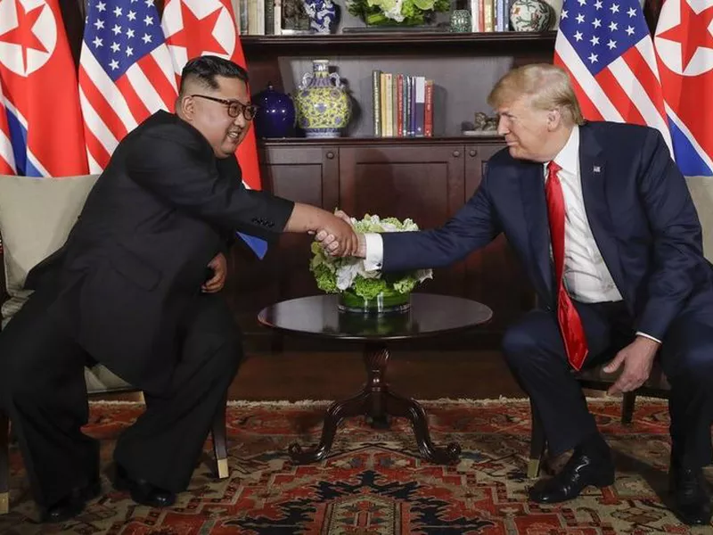 U.S. President Donald Trump shakes hands with North Korea leader Kim Jong Un during their first meetings at the Capella resort on Sentosa Island, in Singapore. (AP)