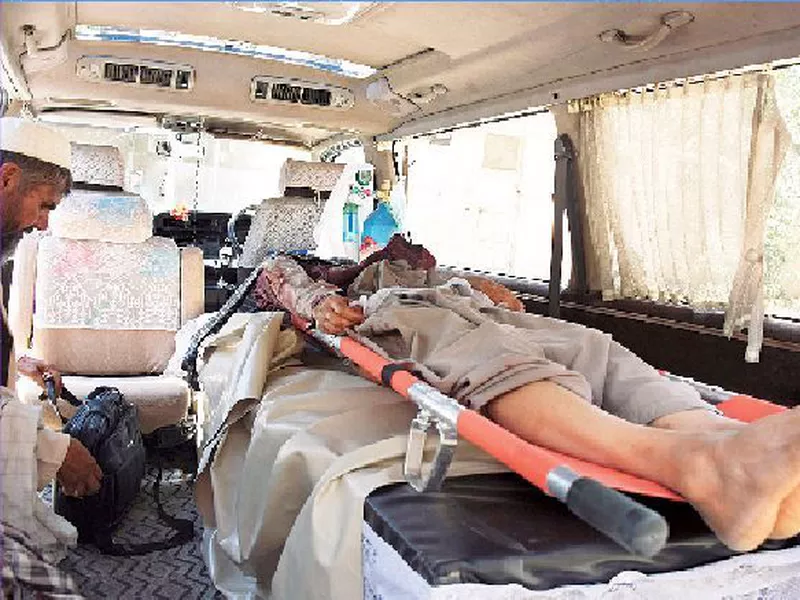 The body of a de-miner lies in an ambulance at a hospital in Kandahar, Afghanistan.