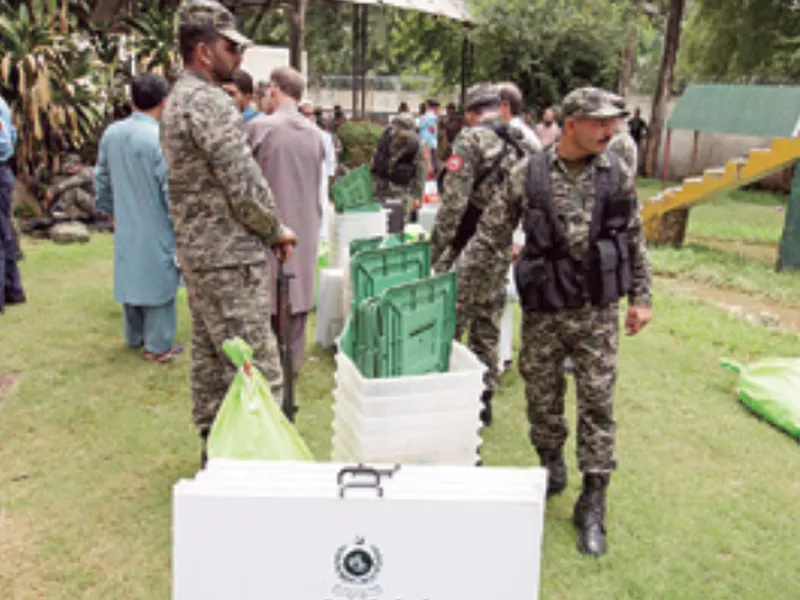 Pakistani soldiers guard a polling material assigned to staff at a distribution
center in Islamabad, Pakistan.