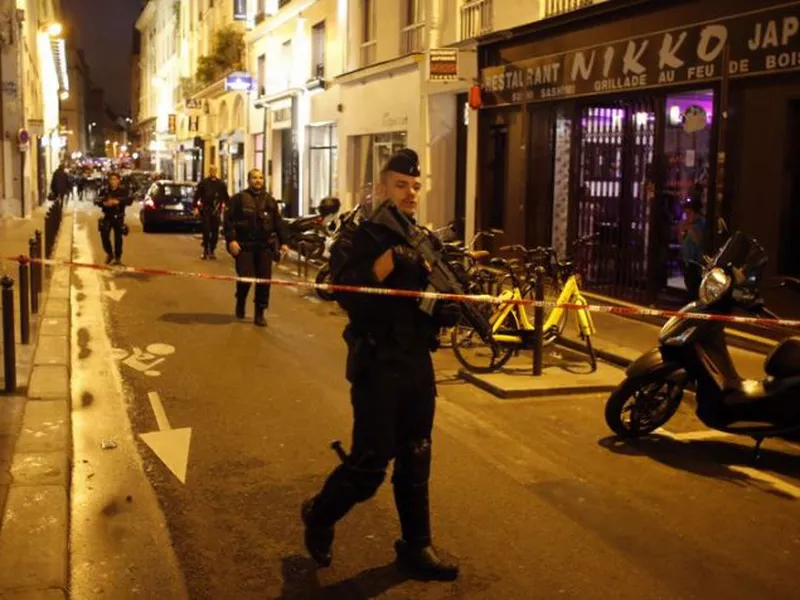 Police officers secure the area after a knife attack in central Paris.