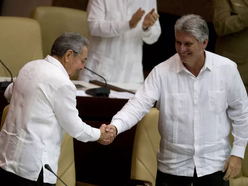 Cuba’s President Raul Castro, left, shakes hands with Vice President Miguel Diaz-Canel, at the closing of the legislative session at the National Assembly in Havana, Cuba. (AP).
