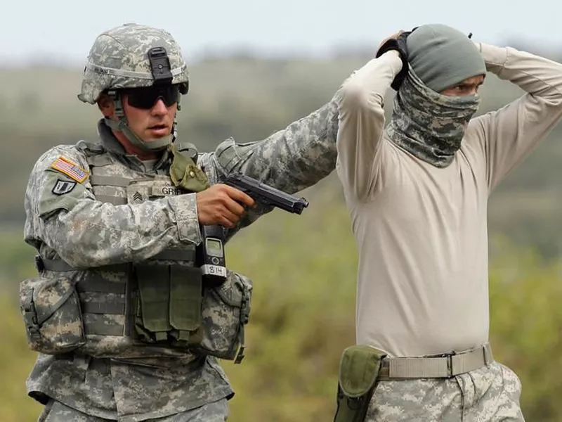 U.S. soldier in the the Deep Steel Task Force arrests a colleague in the role of a suspected terrorist during an exercise in the Babadag training area, Romania.