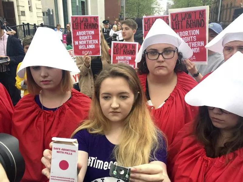 Eleanor Crossey Malone, center, from the socialist feminist group Rosa, after claiming to have taken an abortion pill during a demonstration outside Belfast’s Crown and High Courts, Northern Ireland. (AP)