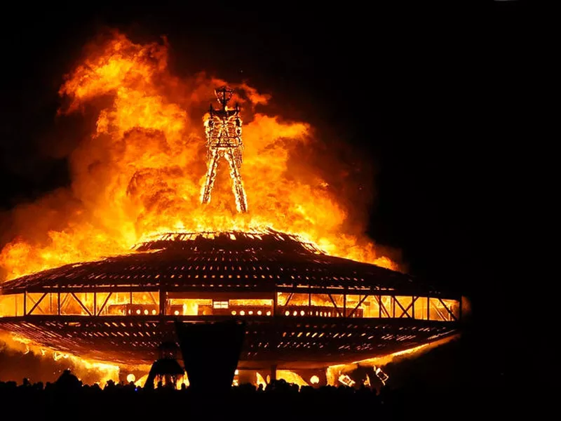 In this Aug. 31, 2013, file photo, the “Man” burns on the Black Rock Desert at Burning Man near Gerlach, Nev. Larry Harvey, the co-founder of the  "Burning Man” festival has died. He was 70.
