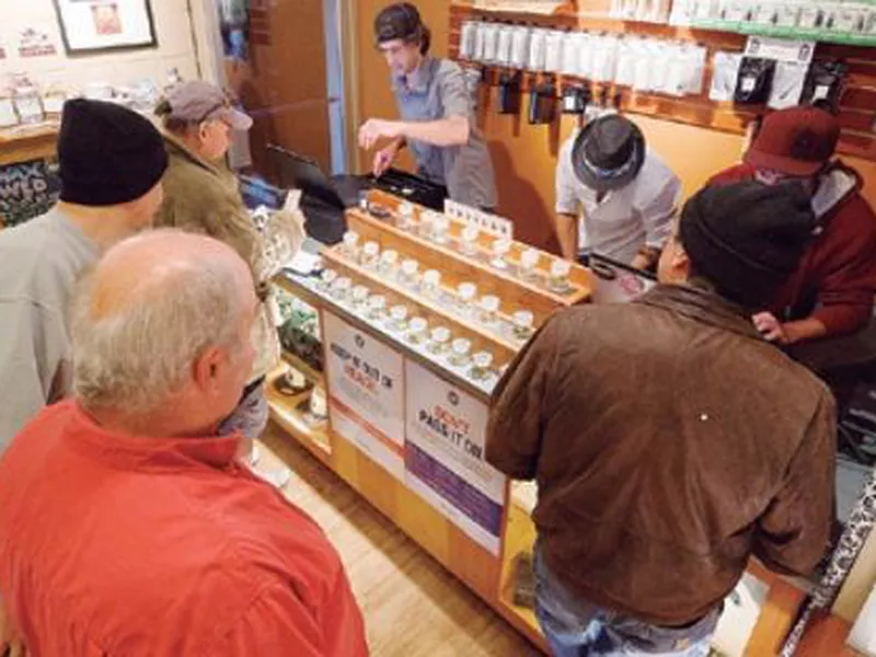 Employees of Amazon Organics, a pot dispensary in Eugene, Ore., help customers purchase recreational marijuana. (AP)