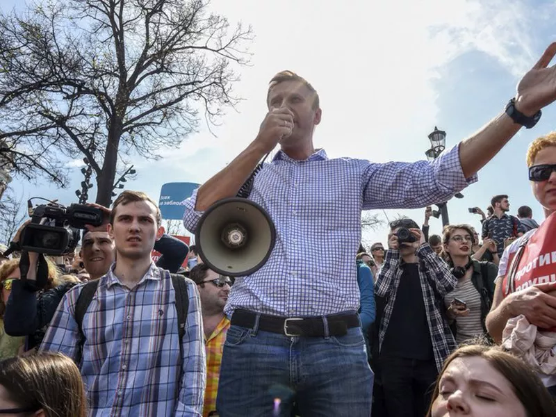Russian opposition leader Alexei Navalny, center, gestures as he speaks using a loudspeaker at a demonstration against President Vladimir Putin. (AP)