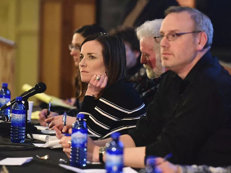 Park County School District 6 board chair Kelly Simone, center, listens to members of the community voice their opinions on Policy CKA, which would allow armed personnel in schools.
