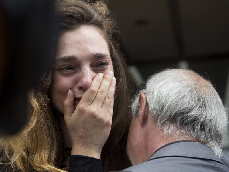 New york daily news staff reporter chelsia Rose Marcius cries as she is hugged by staff photographer todd Maisel after they were both laid off, in New York. (AP)