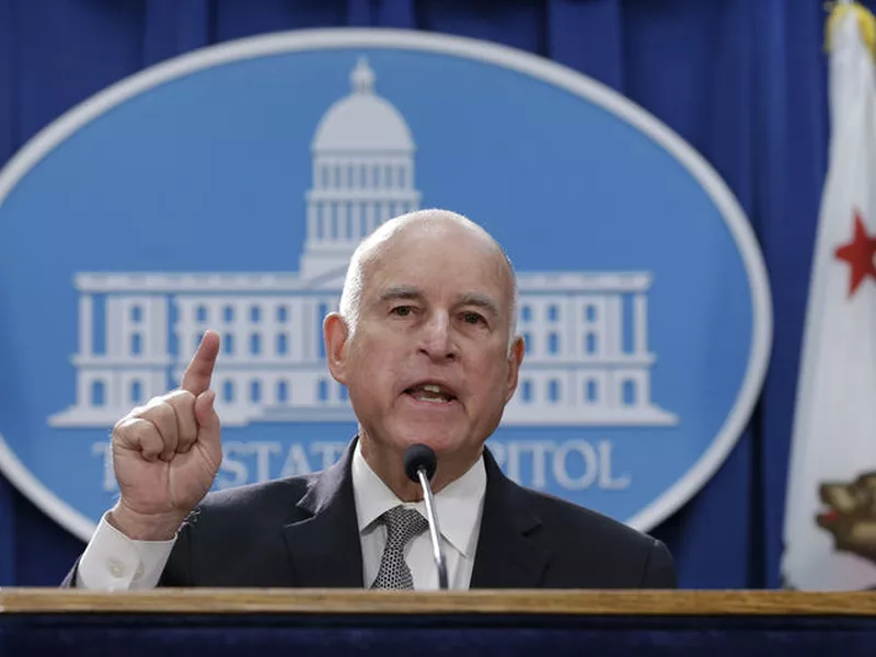 Gov. Jerry Brown discusses a lawsuit filed by 17 states and the District of Columbia over the Trump administration’s plans to scrap vehicle emission standards during a news conference, in Sacramento, Calif.