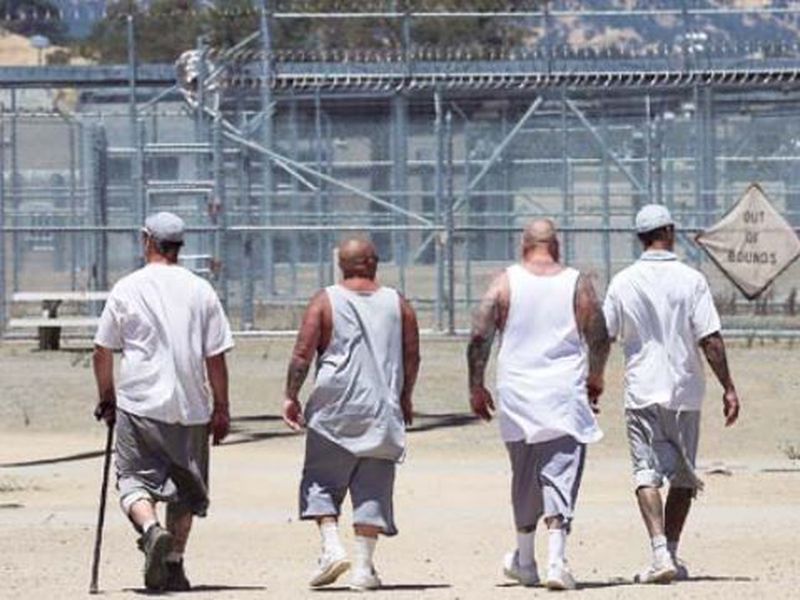 Inmates walk the exercise yard at the California Medical Facility in Vacaville, Calif.