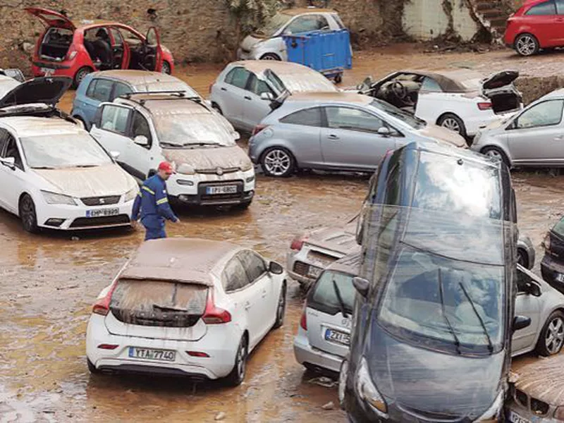 Damaged cars are strewn across an open parking area in northern Athens. (AP)
