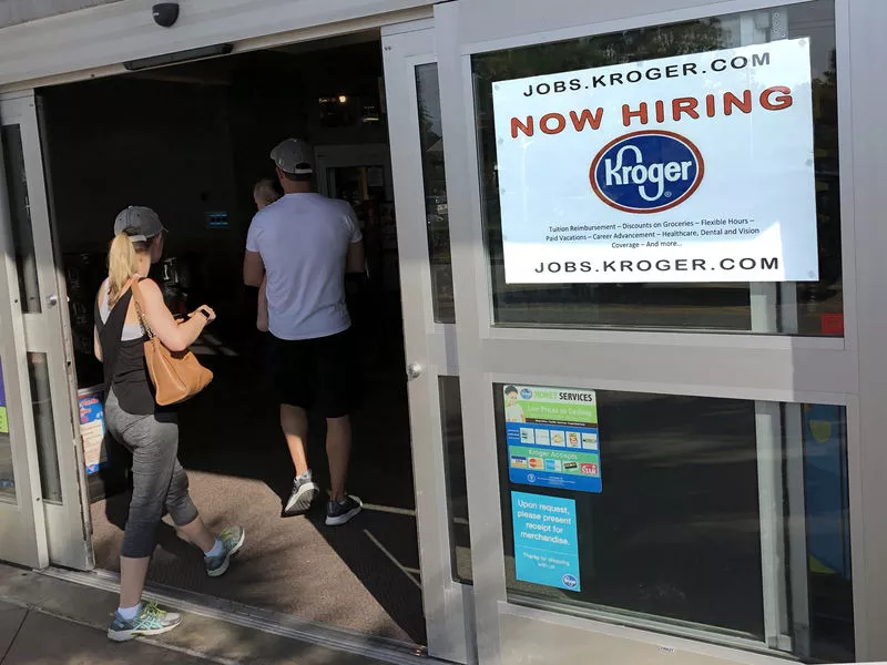 In this photo, a hiring sign hangs in front of a Kroger’s grocery store in Hilton Head, S.C. The Labor Department reports on job openings and labor turnover for April.