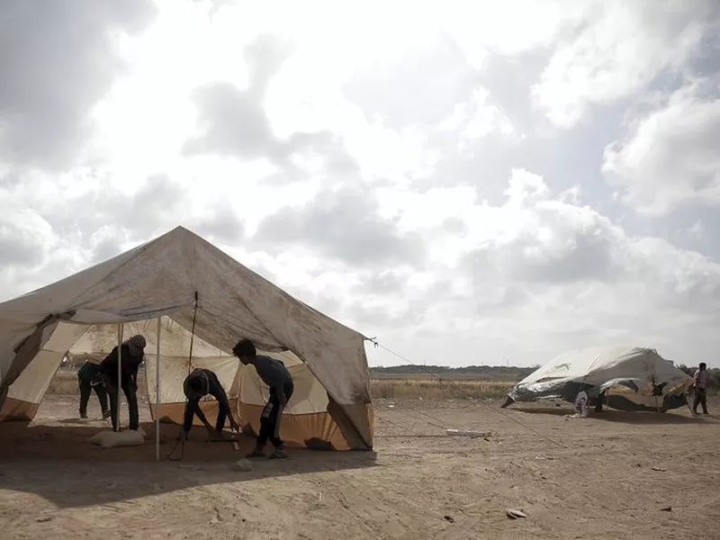 Palestinian protesters set up tents at the Gaza Strip’s border with Israel. Palestinian activists are moving protest encampments closer to Israel’s fence ahead of mass demonstration.