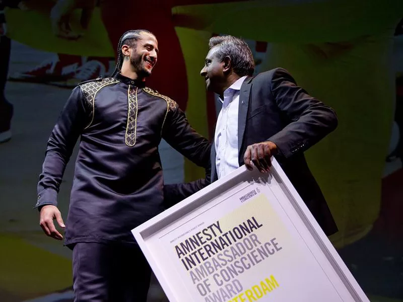 Former NFL quarterback and social justice activist Colin Kaepernick, left, receives the Amnesty International Ambassador of Conscience Award for 2018 from Amnesty International Secretary General Salil Shetty in Amsterdam.