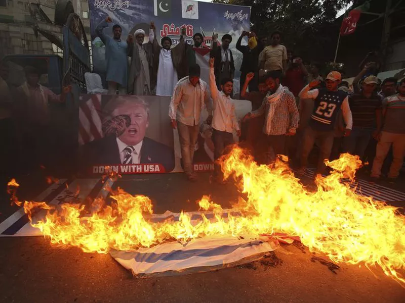 Pakistani Shiite Muslims burn representations of Israeli flags during a rally to protest the move of the U.S. embassy from Tel Aviv to Jerusalem, in Karachi, Pakistan.